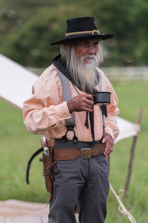 Portrait cowboys post drinking in camping background.の写真素材
