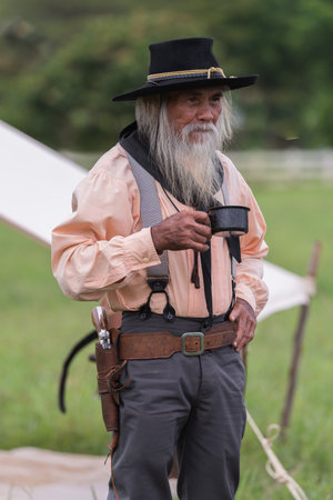 Portrait cowboys post drinking in camping background.の写真素材