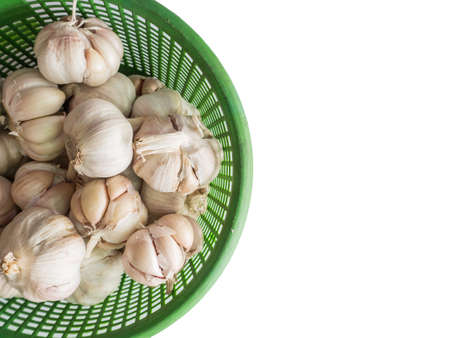 garlics in the basket isolated on white backgroundの写真素材