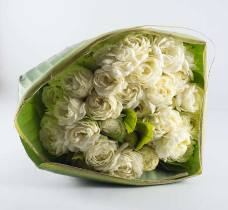 jasmine flower panicle with banana leaf isolate on white backgroundの写真素材