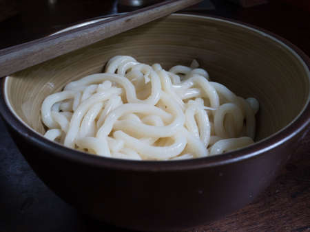 udon in the bowl with chopsticksの写真素材
