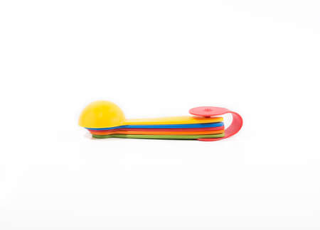 colorful plastic measuring spoon isolatedの写真素材