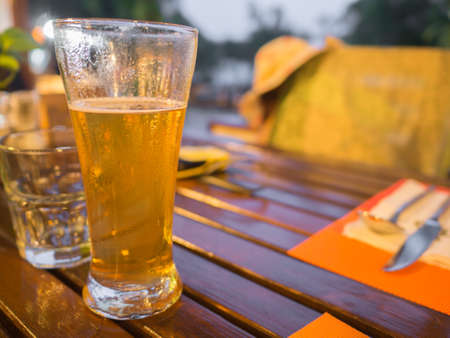 beer in glass on the table (tungsten tone) selective focusの写真素材