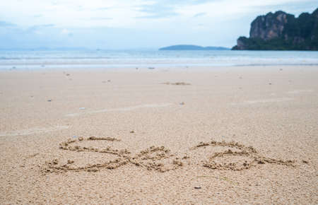 sea written in sand on the beachの写真素材