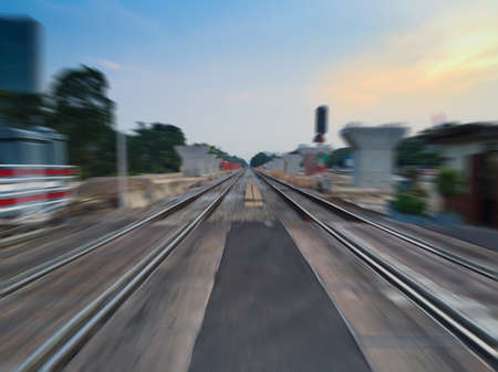 railway track over twilight sky on radial blur backgroundの写真素材