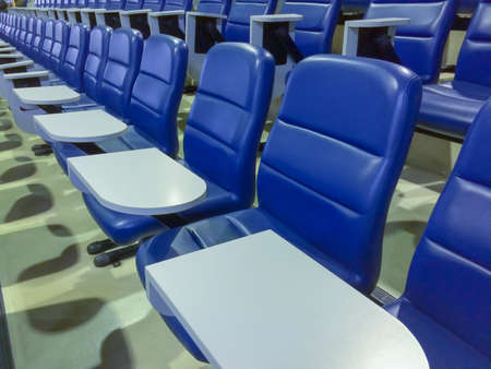 blue chairs seats in empty auditoriumの写真素材