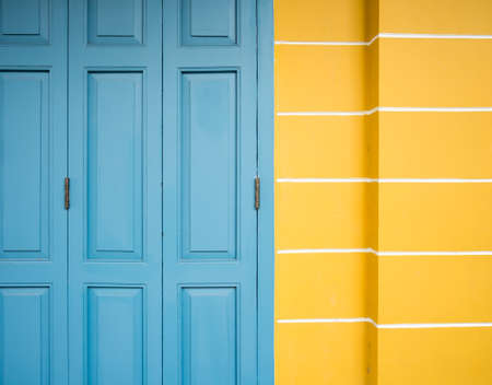 old blue door and yellow wall backgroundの写真素材