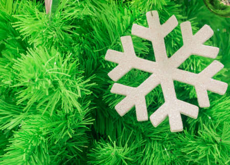 green christmas tree background with snowflake, selective focusの写真素材