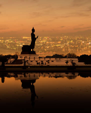 double exposure Buddhist park in Phutthamonthon over cityscape in Sunset.の写真素材