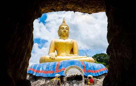 Big Buddha statue, viewed from the cave in Hua Hin THAILANDの写真素材