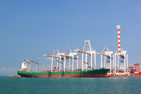 Transportation, cargo ship and containers with large crane at  harborの写真素材