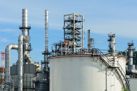 View of oil refinery plant and fuel storage tank with blue sky on a sunny dayの写真素材