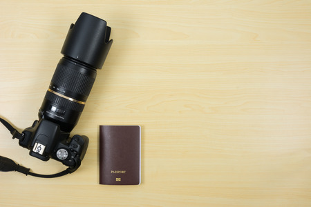 Digital camera and passport on table for travel