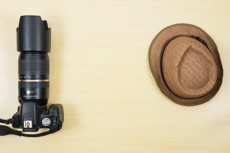 Digital camera and hat on table for travelの写真素材
