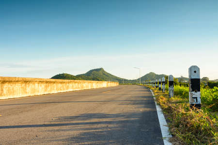 Road curve to mountain with sunshineの写真素材