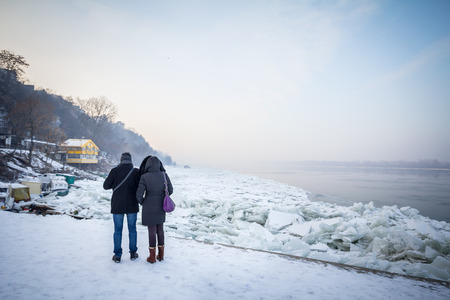 BELGRADE, SERBIA - JANUARY 21, 2016: People walking next to the frozen Danube, due to year exceptionnaly cold weather over the Balkans lasting for more than 10 daysのeditorial素材