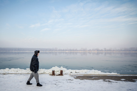 BELGRADE, SERBIA - JANUARY 21, 2016: People walking next to the frozen Danube, due to year exceptionnaly cold weather over the Balkans lasting for more than 10 daysのeditorial素材