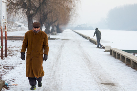 PANCEVO, SERBIA - JANUARY 22, 2017: People walking next to the frozen river Tamis - Timis (a tributary Danube) due to year exceptionnaly cold weather over the Balkans lasting for more than 10 daysのeditorial素材