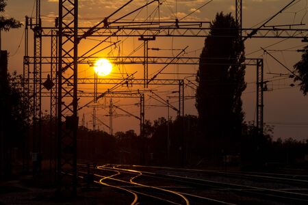 Railway tracks and overhead lines at sunset, Sremska Mitrovica, Serbiaの写真素材