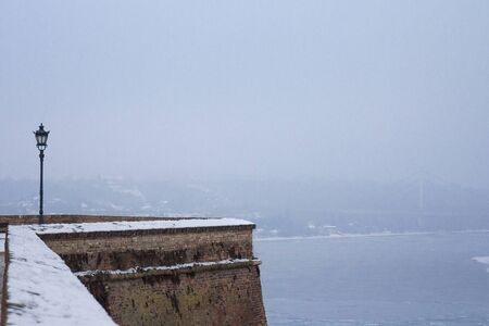 Picture of Petrovaradin fortress wall in winter in Novi Sad, SerbiaExterior walls of Petrovaradin fortress in winter with the frozen Danube river in the backgroundの写真素材