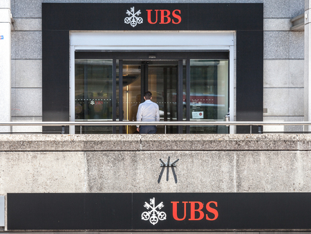 GENEVA, SWITZERLAND - JUNE 19, 2017: Man entering a local branch of UBS (Union Bank Switerland) in Geneva. UBS is one of the main banks of the country, famous for its bank secrecyPicture of a UBS local branch in Geneva Szitzerland. Union Bank Switerlandのeditorial素材