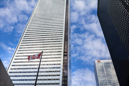 TORONTO, CANADA - DECEMBER 20, 2016: CIBC Headquarters in the center of Toronto, surrounded by skyscrapers and a Canadian flag. The Canadian Imperial Bank of Commerce is one of the main banks of Canadaのeditorial素材