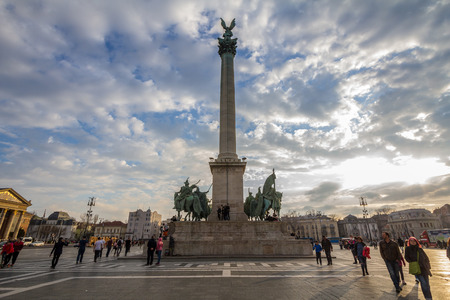 BUDAPEST, HUNGARY - APRIL 7, 2017: Square Heroes (Hosok Tere) in Budapest, Hungary, at Sunset, with tourists climbing the main statue and columnのeditorial素材