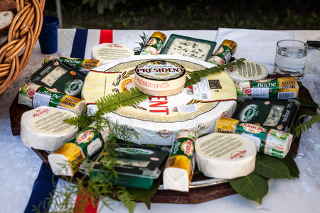 BELGRADE, SERBIA - JULY 14, 2018:  President Camembert surrounded by other French cheese brands of the President group on display. President is a dairy products producer, part of Lactalis

Picture of a President french cheeses standing on a table decorateのeditorial素材