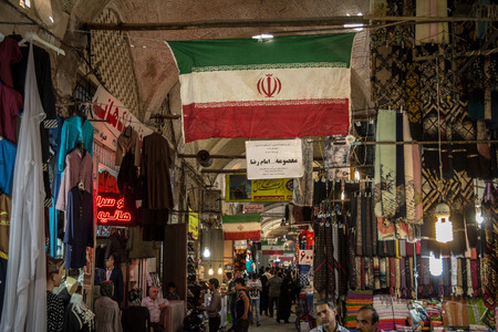 ISFAHAN, IRAN - AUGUST 8, 2018: Street of the Isfahan bazar with an Iranian flag hanging, in a covered alley of the market. Symbol of the Persian architecture, it's a major landmark of the city

Picture of a covered street of the Isfahan bazar, in iran, dのeditorial素材