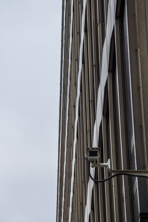 CCTV surveillance and safety camera watching and protecting the exterior of a modern concreite...