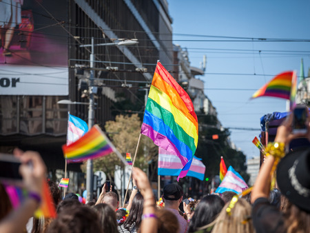 BELGRADE, SERBIA - SEPTEMBER 16, 2018:  Crowd raising and holding rainbow gay flags during the...