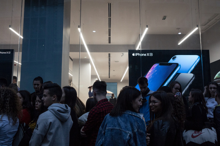 BELGRADE, SERBIA - OCTOBER 26, 2018: People waiting in front of the Apple Store window for the...