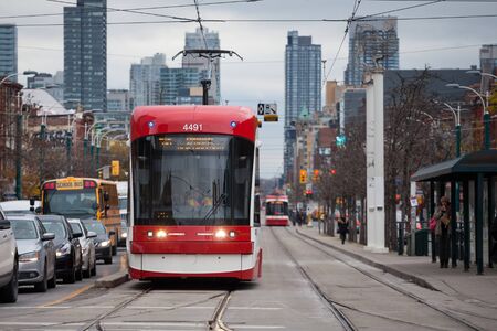 TORONTO, CANADA - NOVEMBER 13, 2018: New Toronto Streetcar on a tram stop on Spadina Avenue, Downtown Toronto, Ontario. It is one of symbols of public transportation in Canadaのeditorial素材