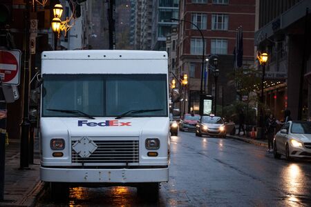 MONTREAL, CANADA - NOVEMBER 5, 2018: Fedex logo on one of their delivery trucks in a street of Montreal, Quebec. Fedex is an American courier specialized in parcels and letters shippingのeditorial素材