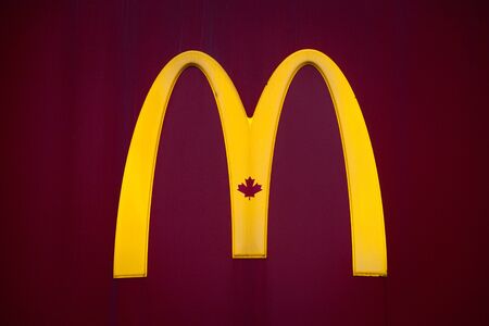 MONTREAL, CANADA - NOVEMBER 5, 2018: Mc Donald's Canada logo with its iconic M in front of a local restaurant, with the Iconic Canadian Maple Leaf in the M of the logoのeditorial素材