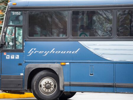 MONTREAL, CANADA - NOVEMBER 6, 2018: Greyhound logo on a  motorcoach bus passing by with speed blur effects. Greyhound Canada is one of the main intercity coach carriers in north Americaのeditorial素材