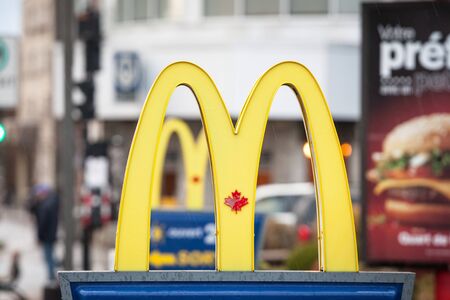 MONTREAL, CANADA - NOVEMBER 6, 2018: Mc Donald's Canada logo with its iconic M in front of a local restaurant, with the Iconic Canadian Maple Leaf in the M of the logoのeditorial素材