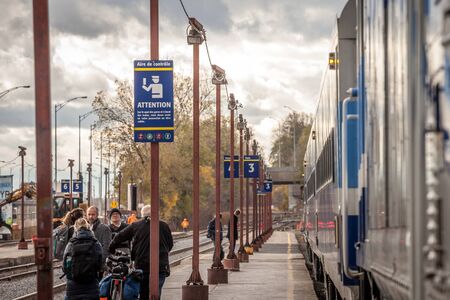 MONTREAL, CANADA - NOVEMBER 7, 2018: Passengers getting ready to board an Exo Montreal suburban train in the commuter train station of Gare Lucien L'Allier in Downtown Montreal, Quebecのeditorial素材