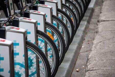 MONTREAL, CANADA - NOVEMBER 7, 2018: Row of bicycle wheels belonging to the bike renatl service Bixi...