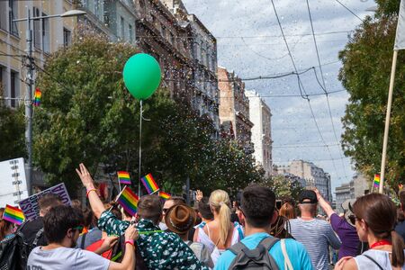 BELGRADE, SERBIA - SEPTEMBER 17, 2017:  Crowd raising and holding rainbow gay flags during the Belgrade Gay Pride. The parade happened this year without trouble, under huge police watch. Picture of a crowd of people holding and raising rainbow flags, syのeditorial素材