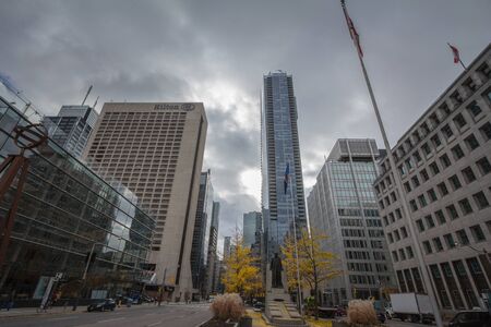 TORONTO, CANADA - NOVEMBER 13, 2018: University Avenue in Downtown Toronto, a typical CBD American street with the Adam Beck statue, office buildings, skyscrapers and high rise towersPicture of a typical North American business district with elevated toのeditorial素材