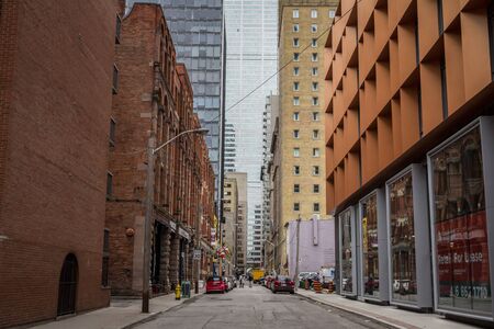 TORONTO, CANADA - NOVEMBER 13, 2018: Small dead end street with shops & older buildings at the...