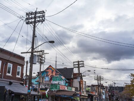 TORONTO, CANADA - NOVEMBER 14, 2018: Typical Kensington market street with the CN tower in background. Kensington market is a hipster district in downtown Toronto, Ontario.Pictures of a typical street of kensington market, in the center of Toronto, Ontaのeditorial素材