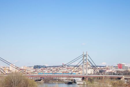 BELGRADE, SERBIA - JUNE 3, 2018: Panorama of Belgrade landscape seen from Sava river, with a Beovoz train passing on a railway bridge in front. Belgrade is a major Serbian touristic destinationPicture of a landscape of the old town of Belgrade, Serbia, のeditorial素材