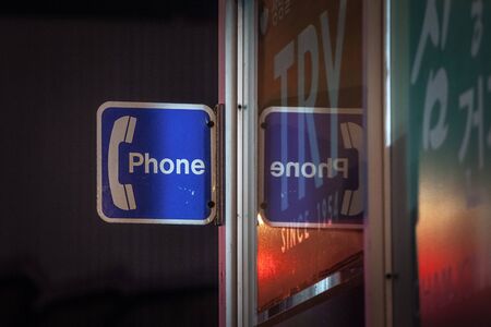 TORONTO, CANADA - NOVEMBER 14, 2018: Sign indicating the presence of a public phone booth in Chinatown Toronto, Ontario, at night. Public Telephones are a technology less and less used

Picture of a payphone sign at night on the chinatown district of Toroのeditorial素材