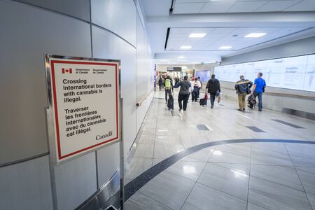 TORONTO, CANADA - NOVEMBER 15, 2018: Sign in Toronto Alan Pearson Airport reminding it is forbidden to export Cannabis outside of Canada, despite the legalization inside the countryPicture of a sign taken in Toronto Alan Pearson Airport from the governmのeditorial素材