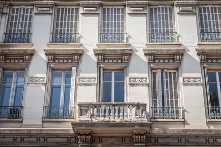 Typical Haussmann style facades, from the 19th century, traditional in the city centers of French cities such as Paris and Lyon, with their traditional stone facades and windowsの写真素材