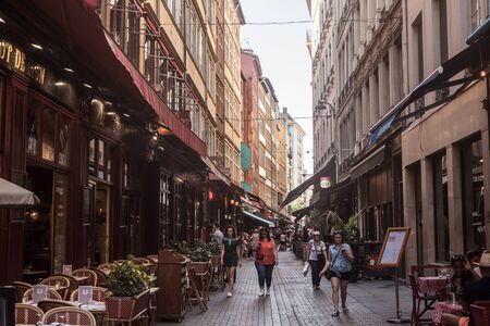 LYON, FRANCE - JULY 13, 2019: Tourists walking in Typical street of the Vieux Lyon (old Lyon) on the...