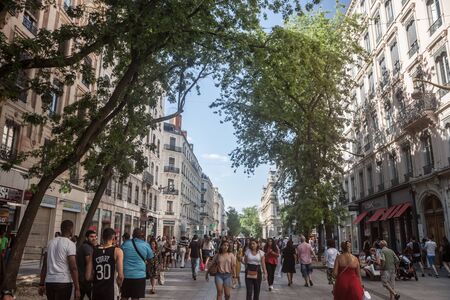 LYON, FRANCE - JULY 13, 2019: Crowd of Pedestrians walking on rue de la Republique Street in Lyon, France, facing a Haussmann style buildings and commercial shop and storesPicture of people walking in the streets of Lyon, France, on a pedestrian boulevaのeditorial素材