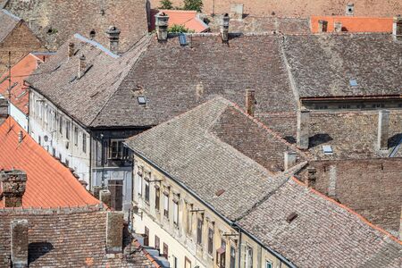 Roofs of typical old Austro-Hungarian style residential houses and building taken with their red and grey tiles tops in the district of Petrovaradin, in Novi Sad, Serbiaの写真素材
